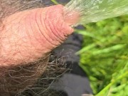Kneeling and pissing in a beautiful field on a sunny day