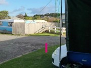 Trashy MILF slut pisses on the grass in front of other campers at the beach 2/16